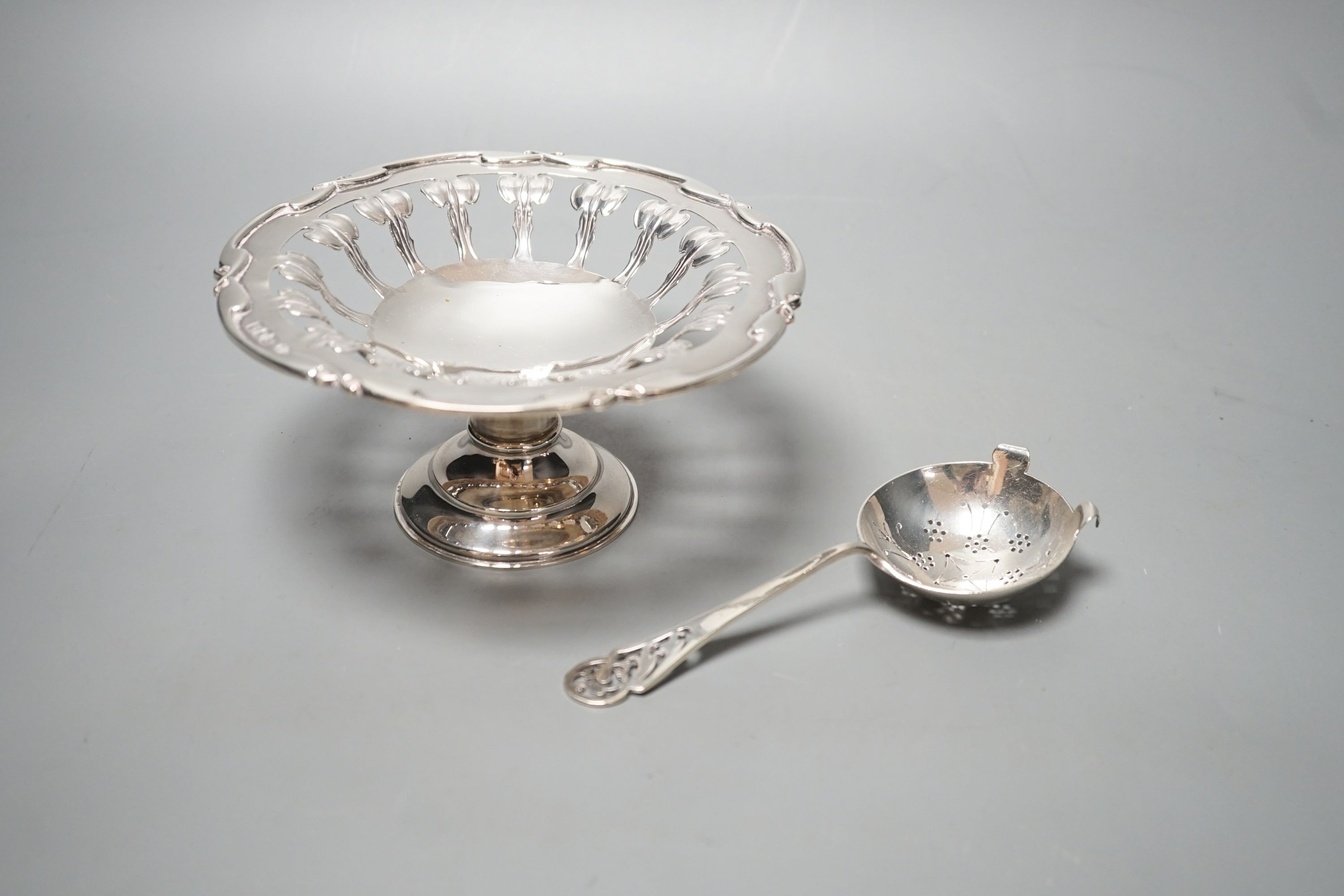 A Edwardian Art Nouveau pierced silver comport, William Hutton & Sons, London, 1903, 15.7cm diameter and a silver sifter spoon, 6.5oz.